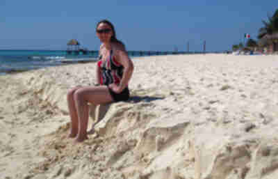 Lisa sits on the eroded sand shelf of the beach